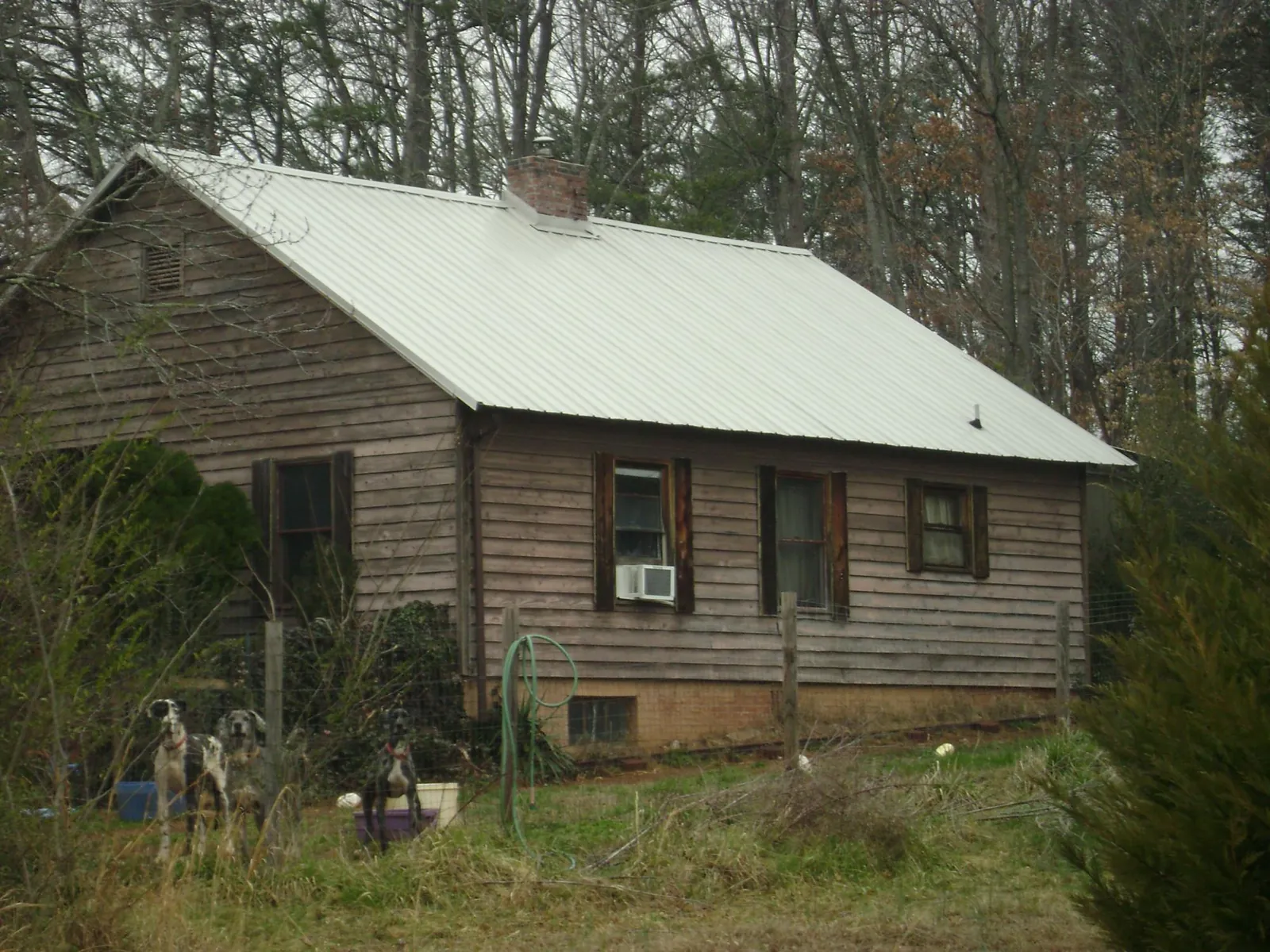 White metal roof on an old wood sided farmhouse, from a Metal Roof Installation job in Jersey Shore
